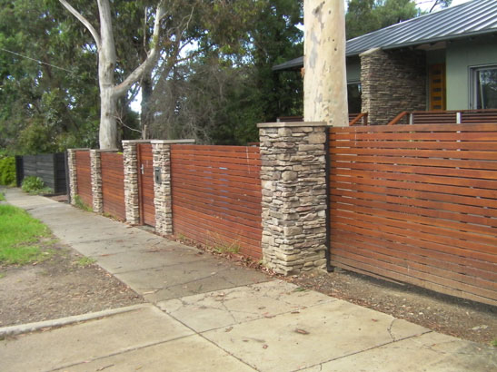 Stone Fence with timber slats